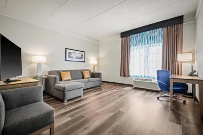 a living room with a couch and a table at La Quinta by Wyndham Miami Airport West in Miami