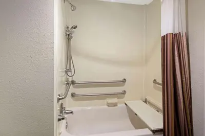 a bathroom with a white tub and a shower at La Quinta by Wyndham Miami Airport East in Miami