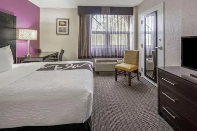 a hotel room with a large bed and a television at La Quinta by Wyndham Miami Lakes in Miami Lakes