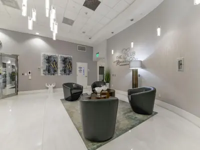 a lobby with chairs and a table in a room at Beautiful Apartment in the Heart of Brickell in Miami