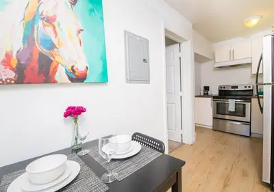 a kitchen with a table and a painting of a horse at Apartments in the Heart of Miami - Port of Miami / Miami Airport in Miami