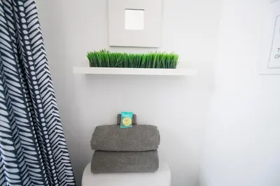 a stack of towels sitting on a toilet in a bathroom at Apartments in the Heart of Miami - Port of Miami / Miami Airport in Miami