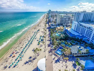 an aerial view of the beach at a resort at Modern studio wqueen bed beach views in Hollywood