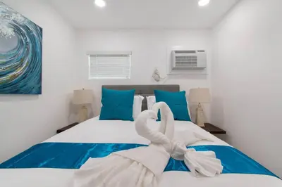 a bedroom with a bed with a towel on it at Renovated studio w ocean views boardwalk steps in Hollywood