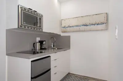 a kitchen with a sink and a microwave at Modern apartment wbeach steps parking in Hollywood
