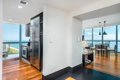 a kitchen and dining room with a view of the ocean at Oceanfront Private Condo at The Setai -2707 in Miami Beach