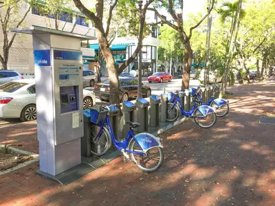 a row of bikes parked next to a parking meter at Ocean View Balcony steps from Restaurants, Peacock Park & Marina in Miami