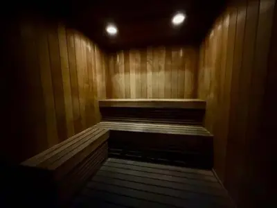 a empty wooden sauna with a wooden floor and lights at Ocean View Balcony steps from Restaurants, Peacock Park & Marina in Miami