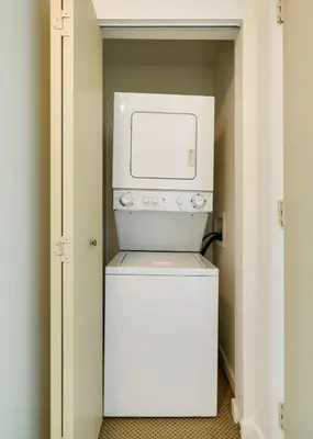 a small white washer and dryer in a closet at City View Balcony steps from Restaurants, Peacock Park & Marina in Miami