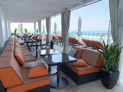 a restaurant with couches and tables and a view of the ocean at City View Balcony steps from Restaurants, Peacock Park & Marina in Miami