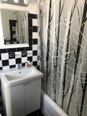 a bathroom with a sink and a shower curtain at Notebook Miami Beach in Miami Beach