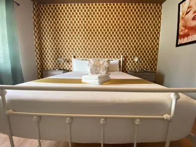 a bed in a bedroom with a large bedvisor at Notebook Miami Beach in Miami Beach
