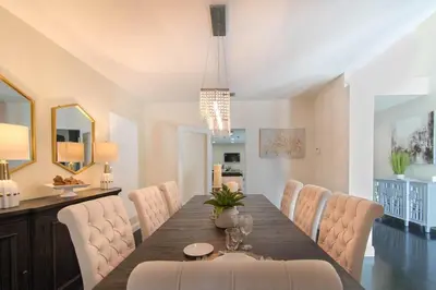 a dining room with a long table and chairs at Spacious 5BR home w heated pool fire pit in Hollywood
