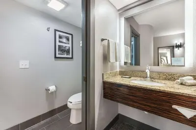 a bathroom with a sink and a toilet and a mirror at Sleep Inn Miami Airport in Miami