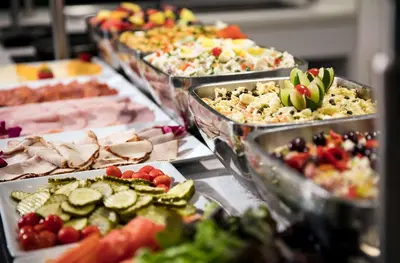 a buffet of different types of food in trays at DoubleTree by Hilton Hotel Miami Airport & Convention Center in Miami
