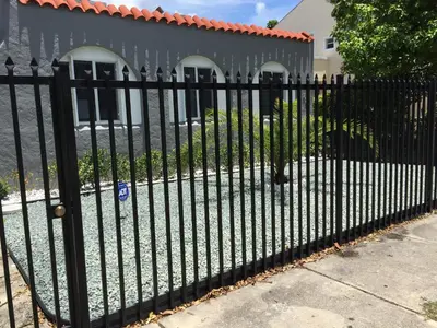 a black metal fence in front of a house at Modern 3/1 house close to Beaches and Midtown in Miami