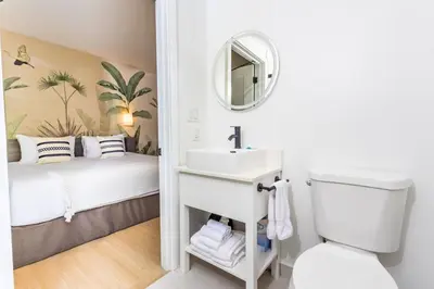 a small bathroom with a sink and a bed at Casa Ocean in Miami Beach