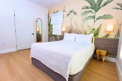 a bedroom with a large bed with white sheets at Casa Ocean in Miami Beach