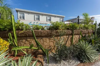 a retaining wall with plants in front of a house at Richard's Hotel in Hollywood