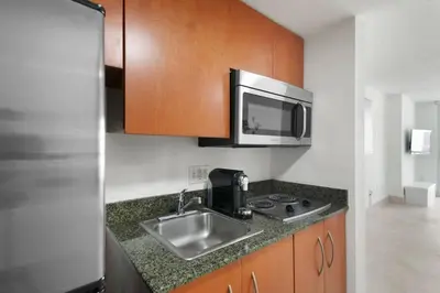 a kitchen with a sink and a microwave at Centric Modern, Stylish Brickell / Miami + FREE Parking in Miami