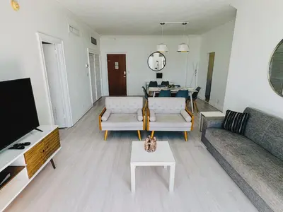 a living room with a couch and a table at Miami Hallandale Condo, Partial Ocean View Direct Beach and Pool Access Miami Hollywood Beach in Hollywood