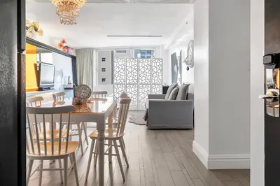 a kitchen and living room with a table and chairs at 1100 West South Beach Luxe Miami Condos by Joe Semary in Miami Beach