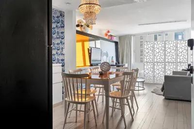a kitchen and dining room with a table and chairs at 1100 West South Beach Luxe Miami Condos by Joe Semary in Miami Beach