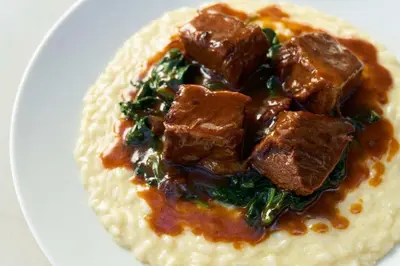 a plate of food with meat on top of mashed potatoes at Gale South Beach, Curio Collection By Hilton in Miami Beach