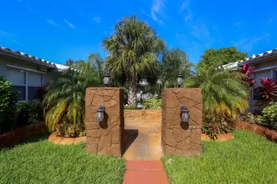 two stone gates in a yard with palm trees at Richard's Pet Friendly Motel in Hollywood