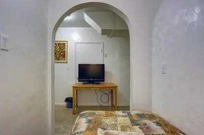 a room with a tv and a table with a television at Richard's Pet Friendly Motel in Hollywood