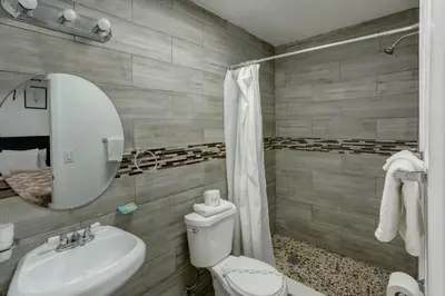 a bathroom with a sink and a toilet and a mirror at Richard's Motel Courtyard in Hollywood