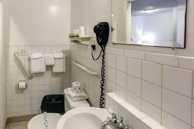 a bathroom with a hair dryer on the wall at Richard's Motel Studios in Hollywood