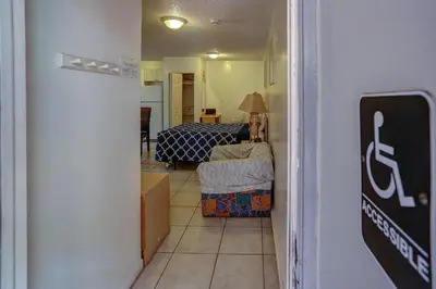 a hallway with a room with a bed and a table at Richard's Motel Studios in Hollywood