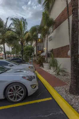 a car parked in a parking lot next to a building at Richard's Motel Studios in Hollywood