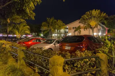 a group of cars parked in a parking lot at night at Richard's Motel Studios in Hollywood