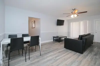 a living room with a table and chairs and a couch at The Dolphin Hollywood in Hollywood