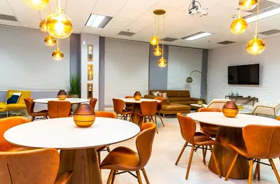 a waiting room with tables and chairs and a couch at Top Stay Miami Platinum Brickell in Miami