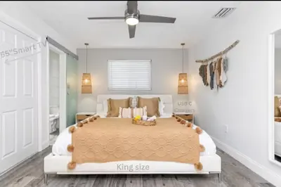a bedroom with a king size bed with a ceiling fan at Pool House 3B-2B King Bed - BBQ - EV in Hollywood