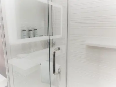 a bathroom with a shower with a glass door at AC Hotel by Marriott Miami Airport West/Doral in Miami