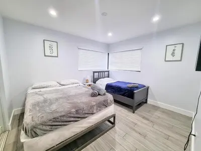 a bedroom with a bed and a table in it at Downtown Hollywood - 3 miles to Beach - Sleeps 8 in Hollywood