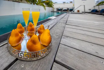 a bowl of pears and two glasses of champagne at Posh South Beach in Miami Beach