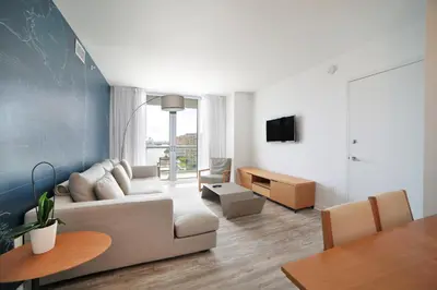 a living room with a couch and a table at Private Ocean Luxury Condos at Beachwalk Resort in Hallandale Beach
