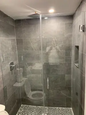a bathroom with a glass shower with a toilet at waterfront lake Hollywood hard rock Airport in Dania Beach
