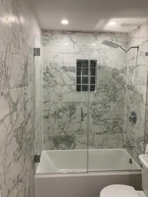 a bathroom with a shower and a tub and a toilet at waterfront lake Hollywood hard rock Airport in Dania Beach