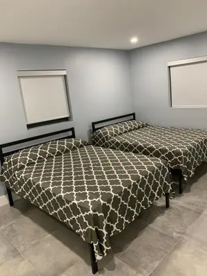 two beds sitting next to each other in a room at waterfront lake Hollywood hard rock Airport in Dania Beach