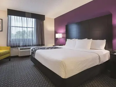 a hotel room with a large bed and a window at La Quinta by Wyndham Plantation at SW 6th St in Plantation