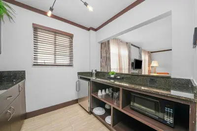 a kitchen with a counter top and a microwave at Lincoln Arms Suites in Miami Beach