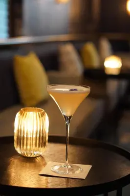 a martini glass sitting on top of a table at Hotel Greystone - Adults Only in Miami Beach