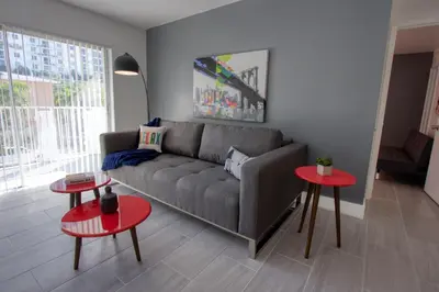 a living room with a couch and two tables at 23 Palms Suites - Midtown Wynwood in Miami