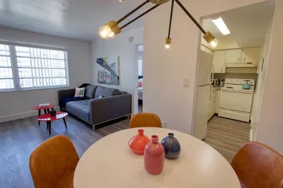 a living room with a table with vases on it at 23 Palms Suites - Midtown Wynwood in Miami